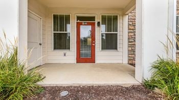 The entrance to a house with a red door